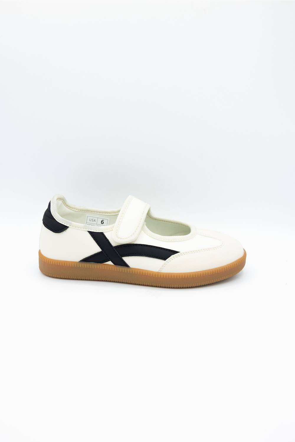 A single white low-top sneaker with a black side stripe and a brown gum sole, photographed from the side against a plain white background.