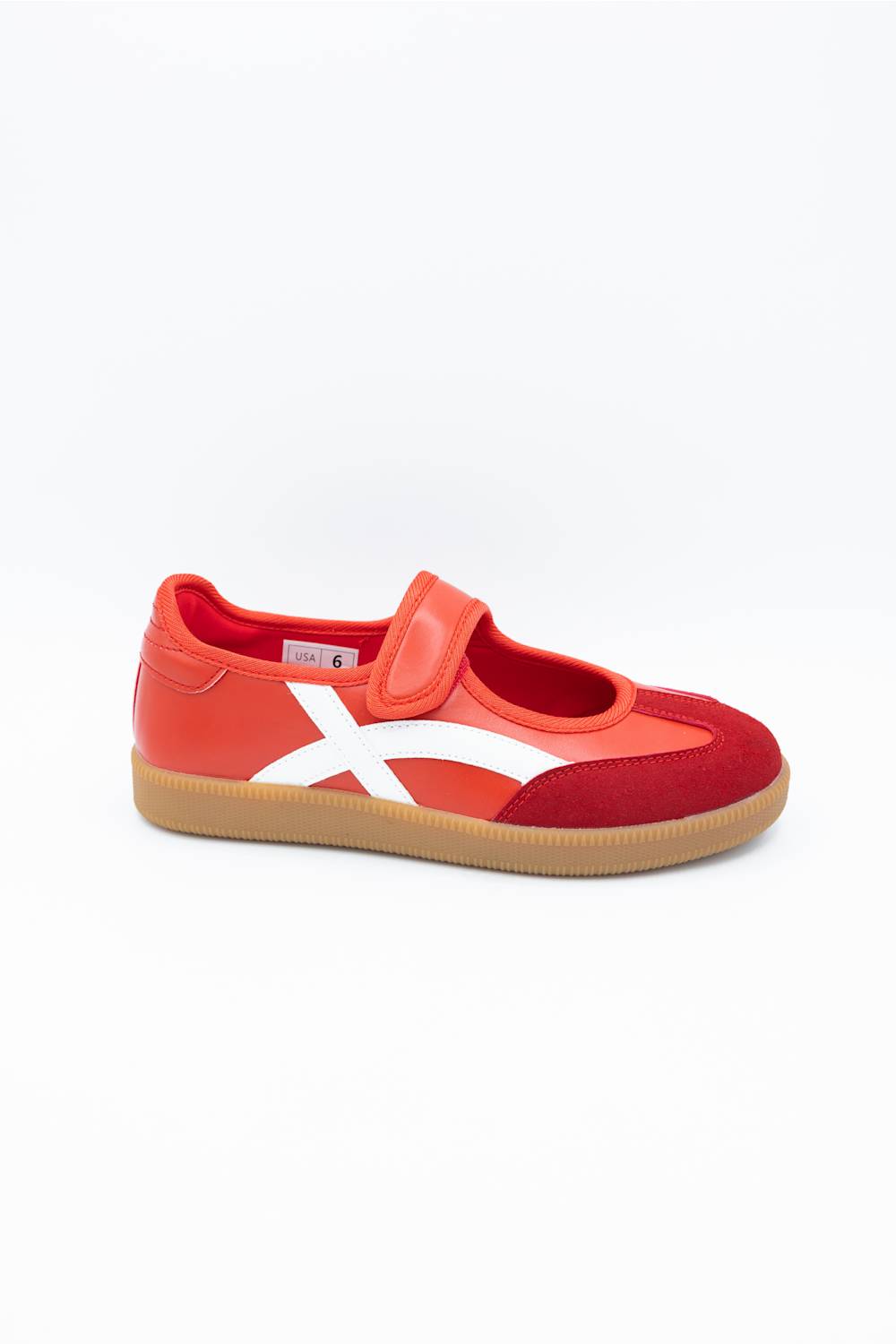 A red and orange low-top sneaker with a white side stripe and a gum sole, photographed on a clean white background.