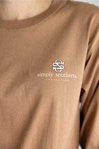 A brown long-sleeve t-shirt with a graphic of three western-style geese on the back, featuring the text 'JUST A SILLY GOOSE' and 'simply southern.' on the back, and 'simply southern.