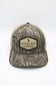 Local Boy Outfitters Youth Classic Hex Trucker Hat for Boys in Camo; Camouflage baseball cap with 'Local Boy Outfitters' logo on a white background