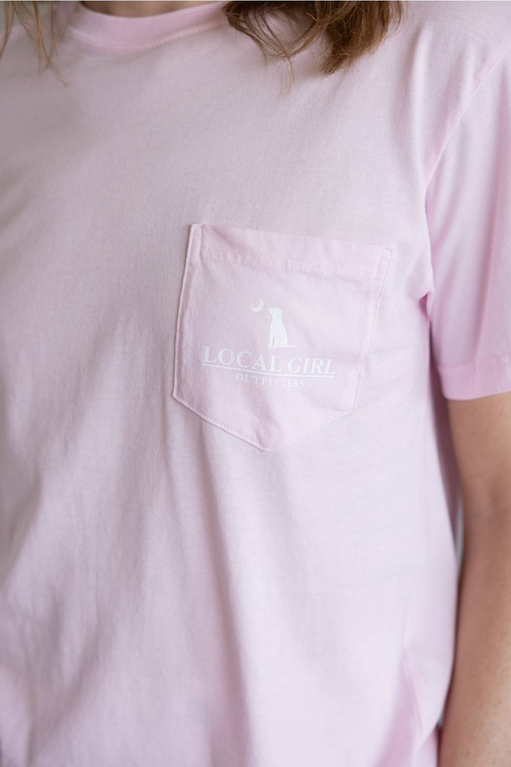 Local Girl Absolute Localflage T-Shirt for Women in Blossom; Pink t-shirt with a logo on the chest worn by a person