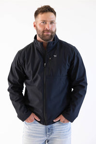 A man wearing a dark navy blue zip-up jacket with a small white horse logo on the left chest, paired with light blue jeans, against a plain white background.