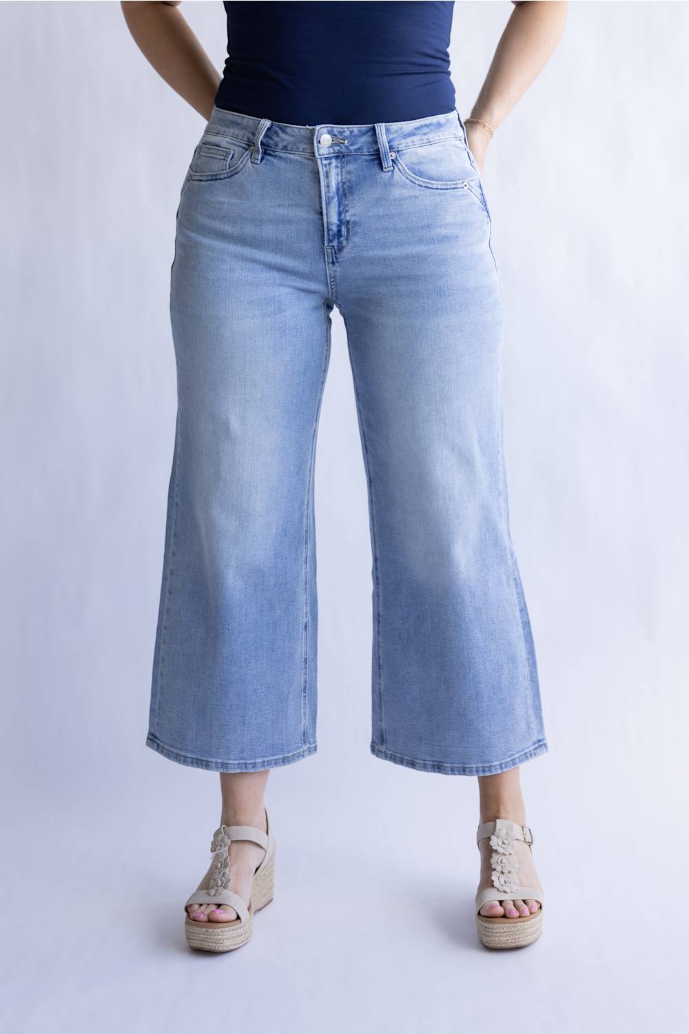 Mica Mid Rise Wide Crop Jeans for Women; Person wearing light blue jeans and sandals on a white background