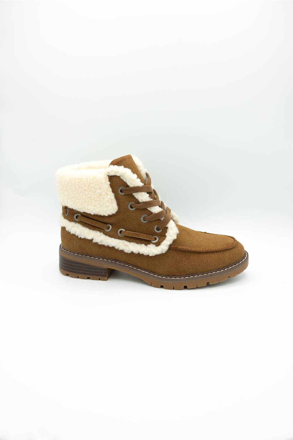A brown suede ankle boot with a thick cream-colored shearling lining and matching laces, shown from a side profile on a white studio background.