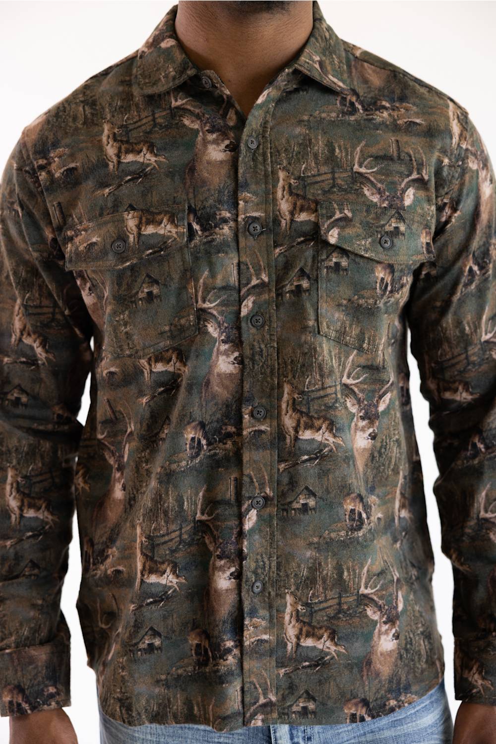 A man wearing a long-sleeve button-up shirt with an all-over woodland deer camouflage pattern in shades of brown, green, and beige.