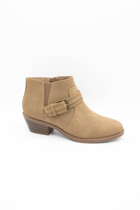 A tan suede ankle boot with a low stacked heel and a decorative buckle strap across the instep, shown from a side profile on a white background.