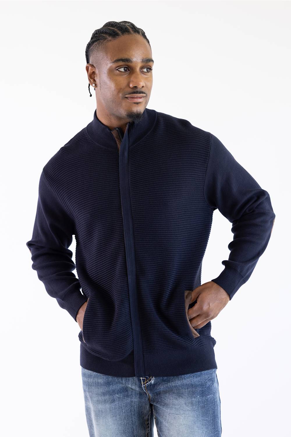 Man wearing a navy mock neck jacket standing against a white background