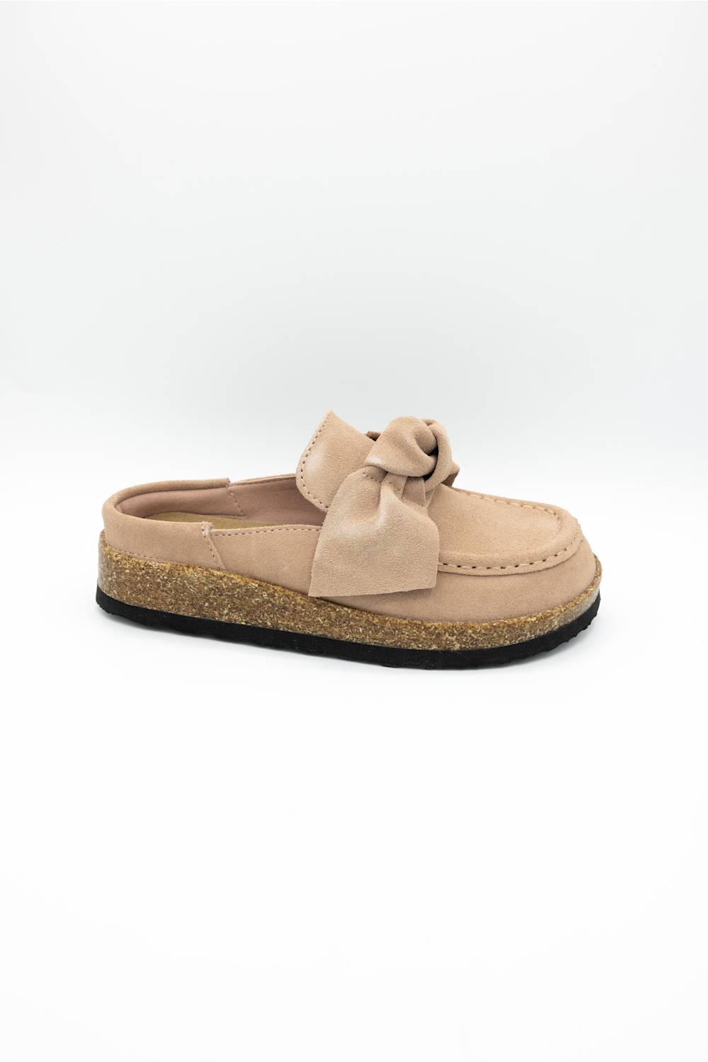 A single slip-on mule shoe in blush suede with a matching fabric bow on the vamp and a cork-textured midsole, shown against a plain white background.