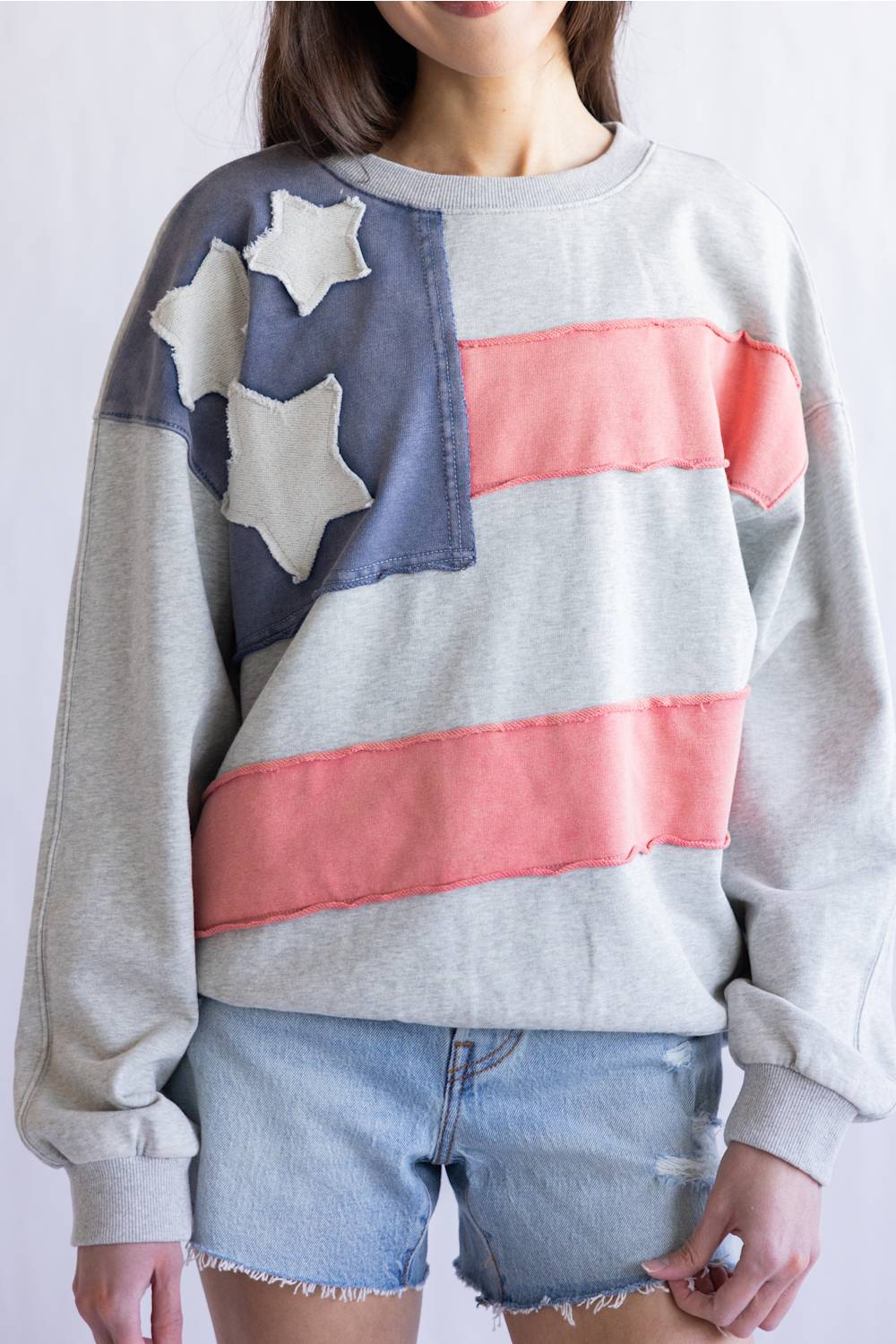 Flag USA Sweatshirt for Women in Grey; Person wearing a sweatshirt with an American flag design on a plain background