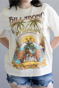 Person wearing a 'Billabong Aloha' t-shirt with tropical graphics on a plain background