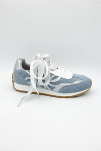 A light blue suede and mesh sneaker with white laces, white midsole, and a brown gum outsole, shown from a side profile on a light gray background.