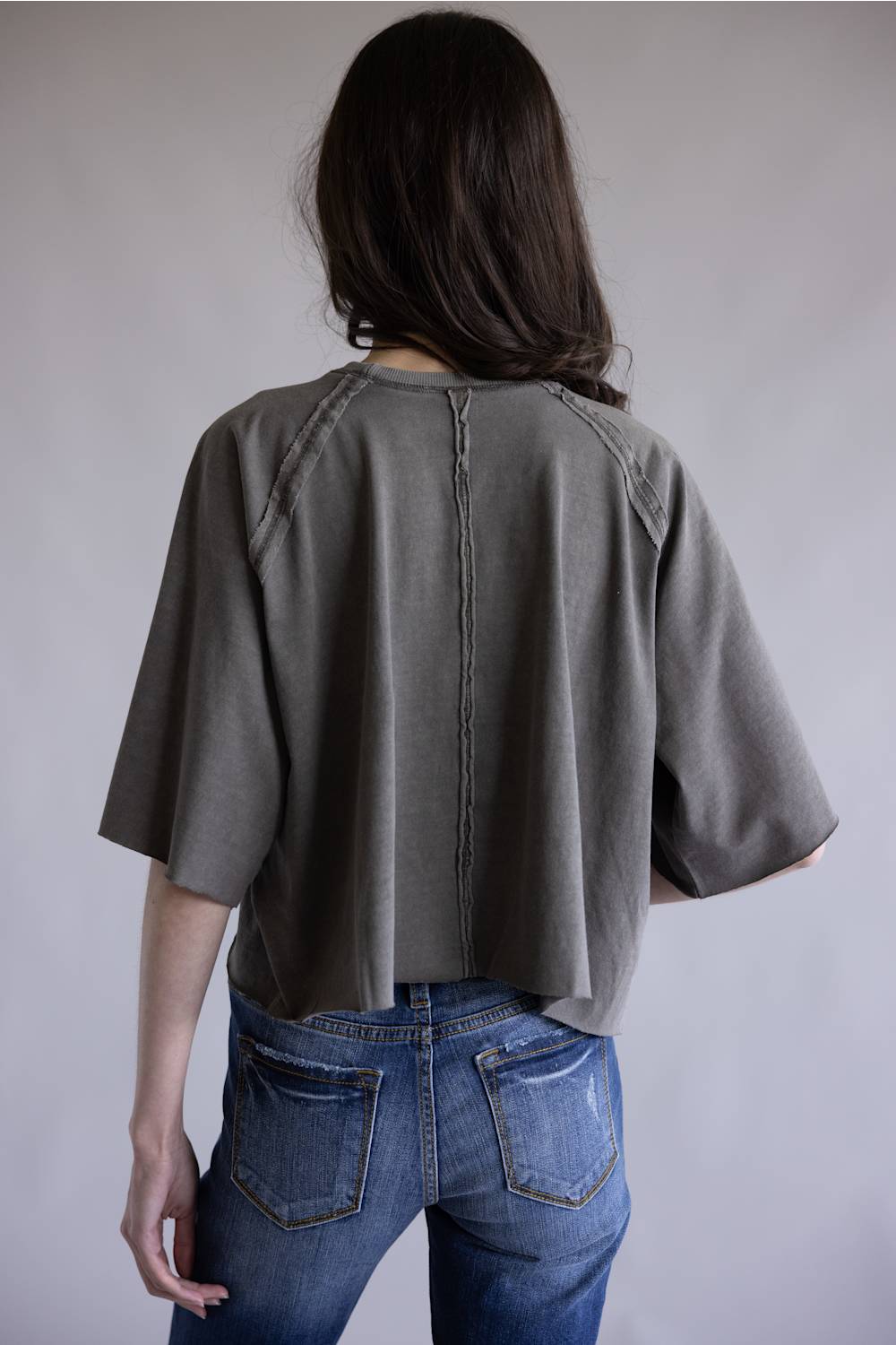 Simply Southern Washed Tee for Women in Grey; Person wearing a gray oversized shirt and blue jeans against a plain background