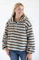 A woman wearing a fuzzy quarter-zip pullover sweater with horizontal brown, light blue, and cream stripes, paired with blue jeans, against a plain white background.