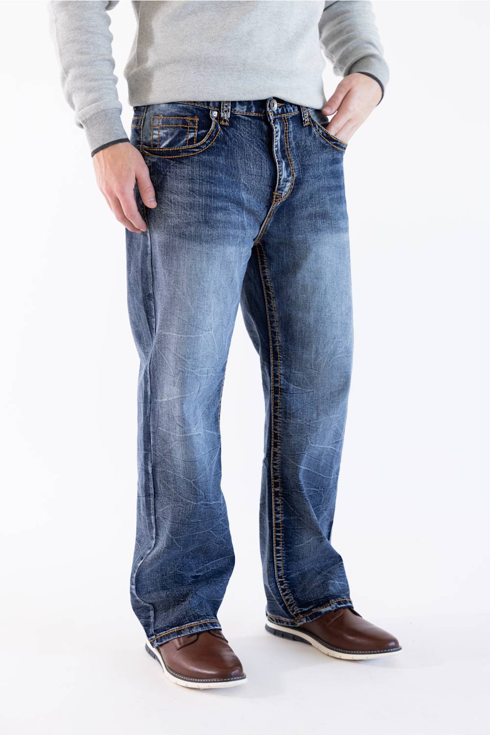 Side profile view of Men's True Luck Truman Loose Straight jeans in a dark wash, emphasizing the relaxed straight-leg silhouette, distinct fading along the thighs and shins, and styled with a gray sweater and brown shoes.