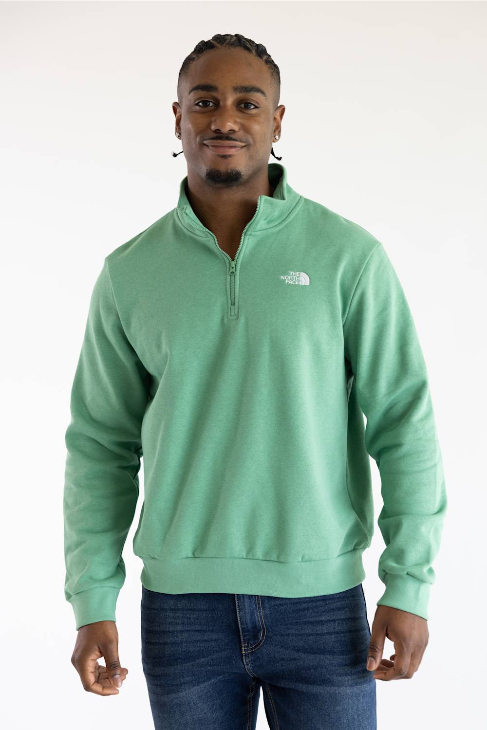 A man wearing the The North Face Evolution Simple Dome ¼ Zip Neck for Men in Dimmed Algae Green with a white The North Face Logo on the upper left chest.