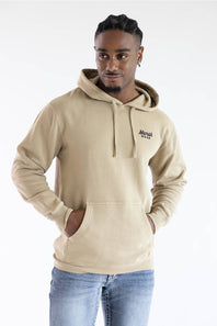 A man wearing a beige pullover hoodie with a drawstring hood and kangaroo pocket, featuring a small black embroidered 'Marsh' logo on the left chest, paired with blue jeans against a plain white background.