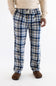 A person wearing blue, white, and beige plaid lounge pants with a drawstring waist, paired with a cream sweater and brown slippers, photographed against a plain white studio background.