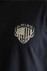 Close-up view of the chest graphic on a black shirt, featuring an American flag shield framed by deer antlers with the Ariat brand name arched above it.
