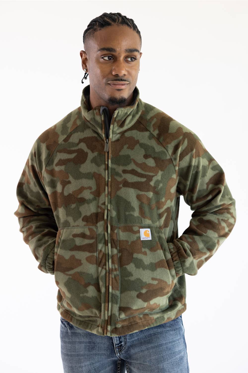 Front view of a male model wearing a full-zip fleece jacket featuring an Army Green camouflage pattern with the Carhartt logo patch on the left pocket.
