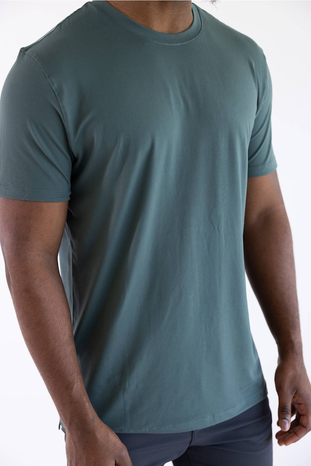 Close-up product shot of a man wearing the 7Diamonds Core Crew T-Shirt in Drake green, showing the short sleeves and relaxed fit.