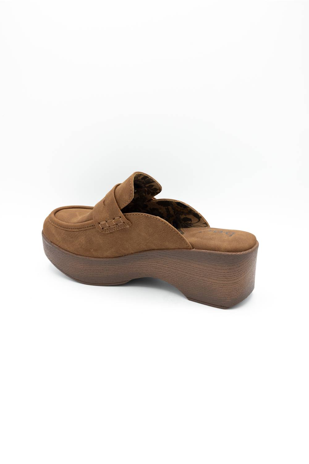 A single brown suede slip-on wedge mule shoe shown from a side-rear angle on a clean white background.