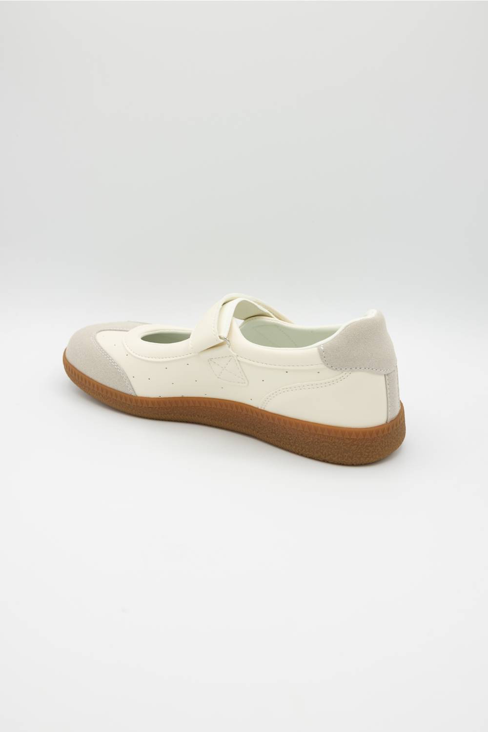 A single cream-colored leather shoe with a brown gum sole, shown from a side-rear angle on a light gray background.