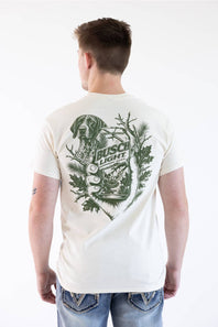 A man viewed from behind wearing a white t-shirt with a large green graphic print on the back featuring a dog, antlers, and the text 'Irish Light'.