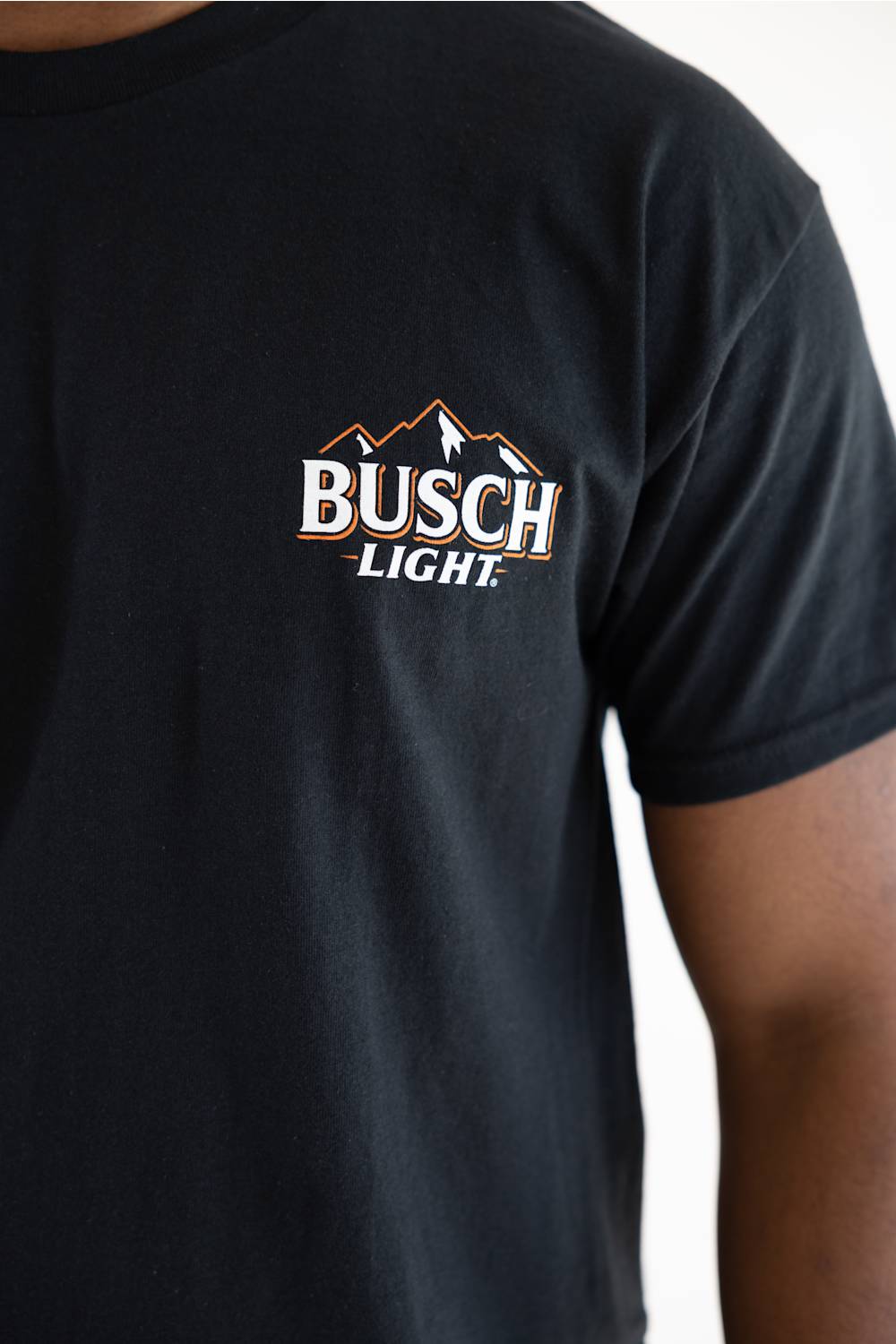 Busch Light Can Evolution T-Shirt for Men in Black (Front View showing the Busch Light mountain chest logo on the left chest).