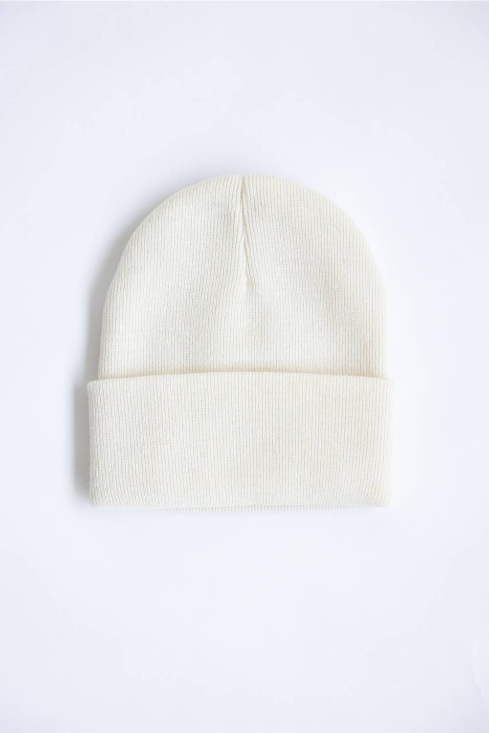 A cream-colored ribbed knit beanie hat with a folded cuff, shown flat against a plain white background.