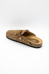 A single brown clog-style slip-on shoe with a dotted pattern and a cork-look midsole, photographed from a side angle on a light gray background.