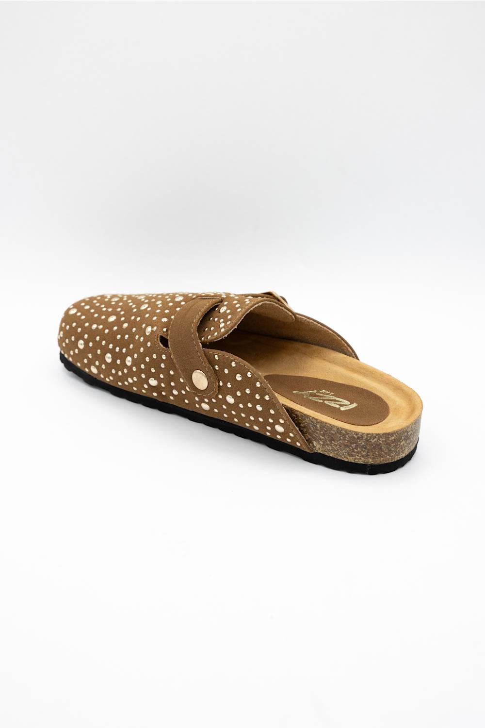 A single brown clog-style slip-on shoe with a dotted pattern and a cork-look midsole, photographed from a side angle on a light gray background.
