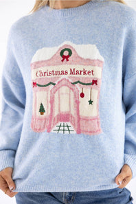 Upclose sweater design of a Christmas market storefront