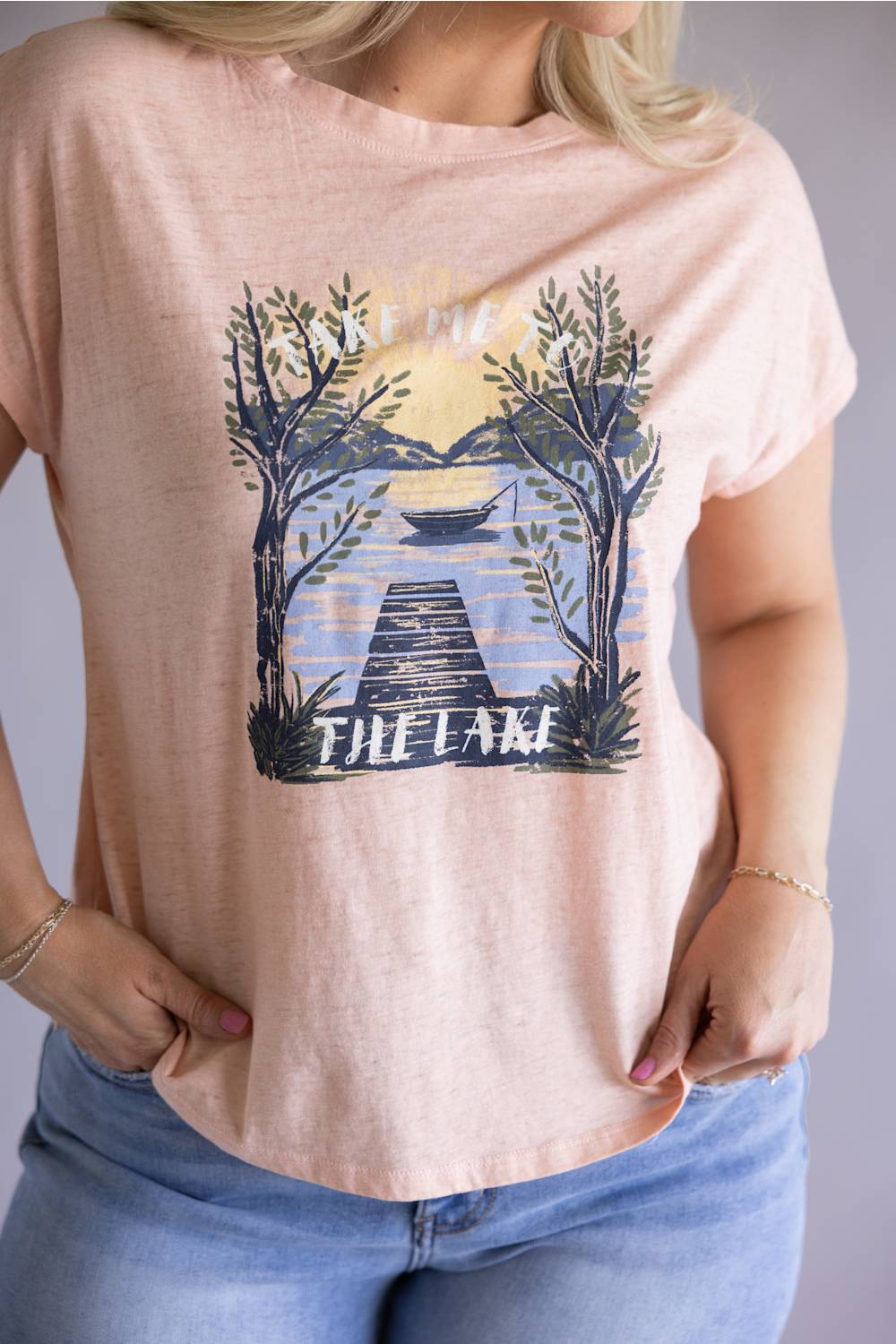 C&C California Lake Tee for Women in Pink; Person wearing a t-shirt with a 'The Lake' graphic design.