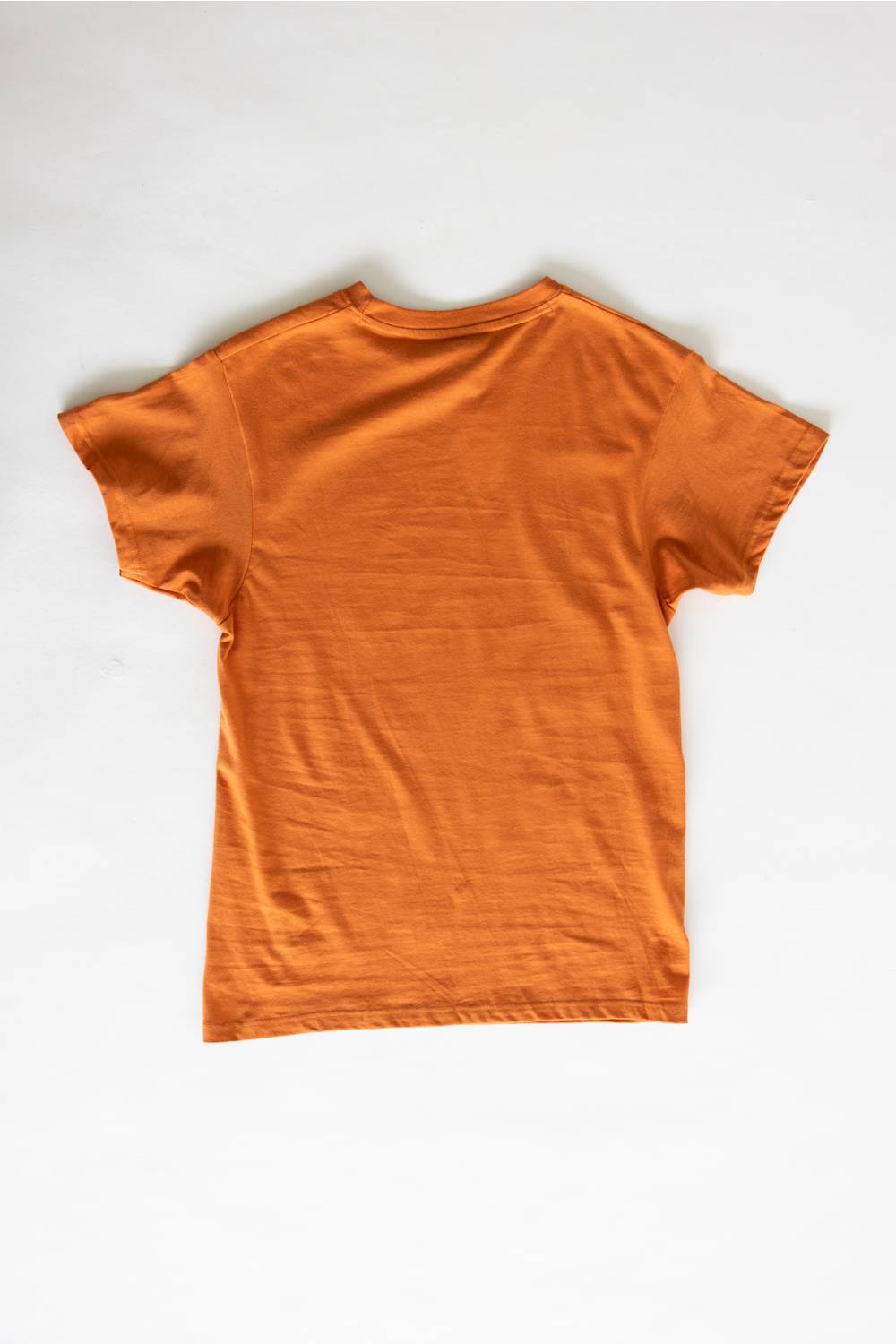 An orange short-sleeve crewneck t-shirt laid flat against a light gray background.