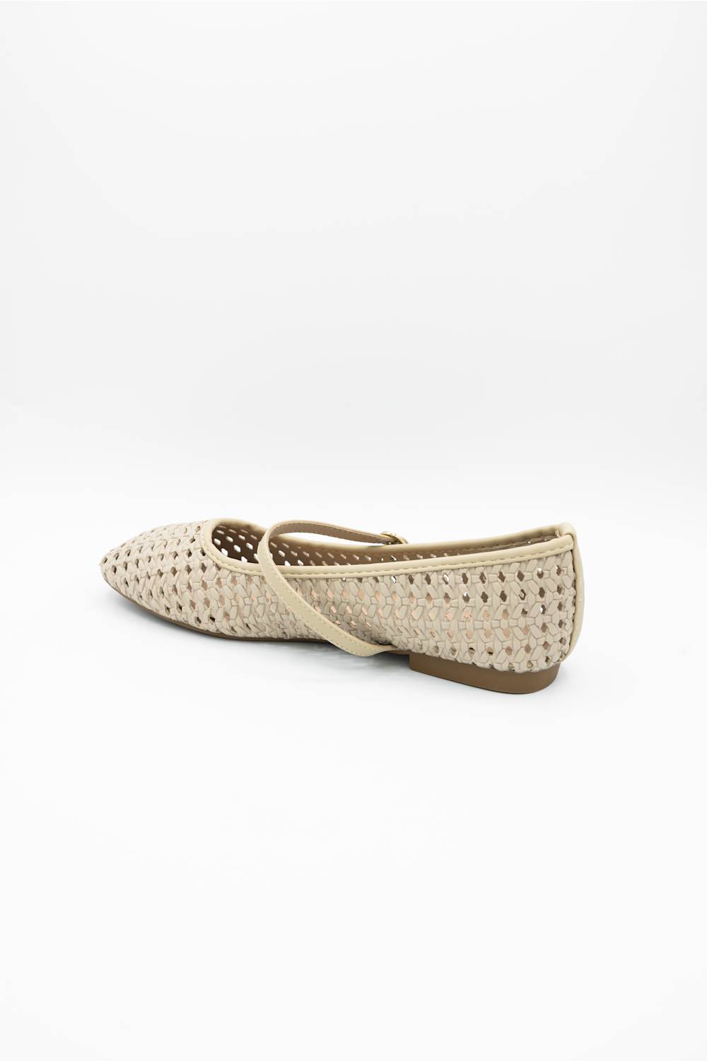 A single woven flat shoe in a light beige or cream color, shown from a side profile view against a plain white background.