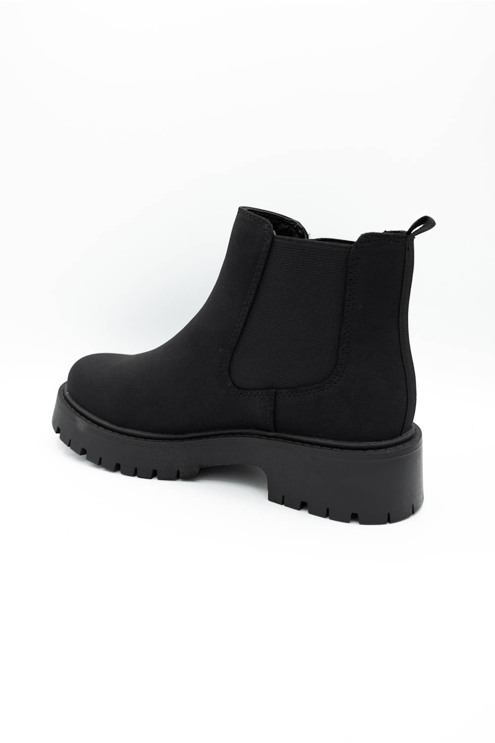 A single black Chelsea-style ankle boot with a chunky lug sole, shown from a side-rear angle on a plain white background.
