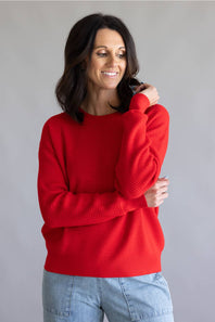 Waffle textured sweater top in a vibrant red color, with thick hems and cuffs 