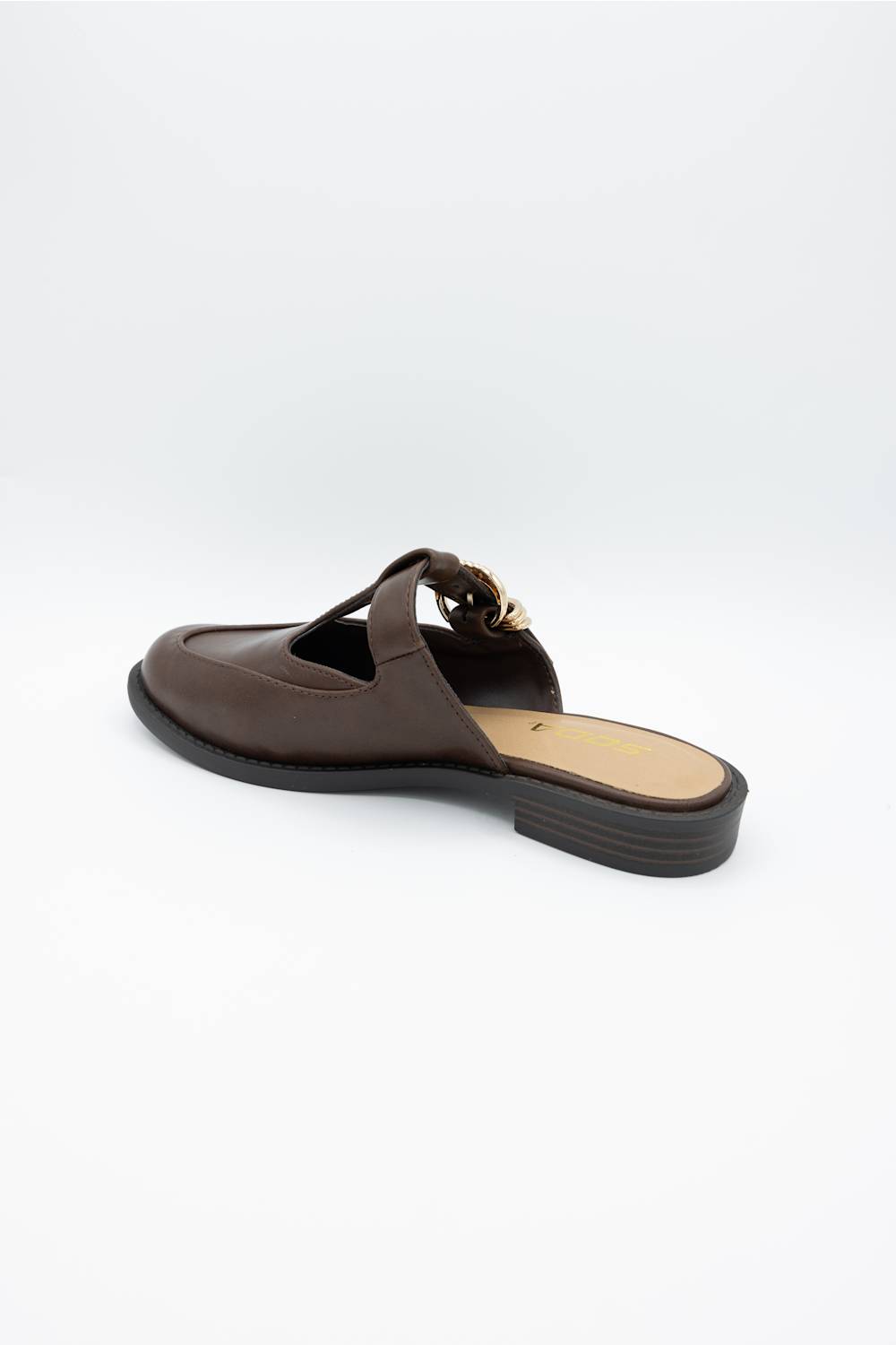 A dark brown leather mule sandal with a decorative strap and a gold-tone metal accent, shown from a side profile on a light gray background.