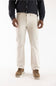 A person wearing light beige straight-leg dress pants, a dark navy long-sleeve button-up shirt, and brown suede shoes, shown from the waist down against a plain white studio background.