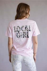 Local Girl Absolute Localflage T-Shirt for Women in Blossom; Person wearing a pink t-shirt with camo print text on the back against a plain background