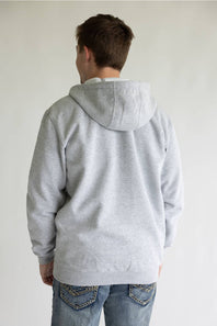 A person viewed from the back wearing a light gray heather pullover hoodie and blue jeans against a plain light background.