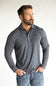 A muscular man wearing a dark gray long-sleeve polo shirt with a small embroidered logo on the left chest, paired with blue jeans, standing against a plain white studio background.