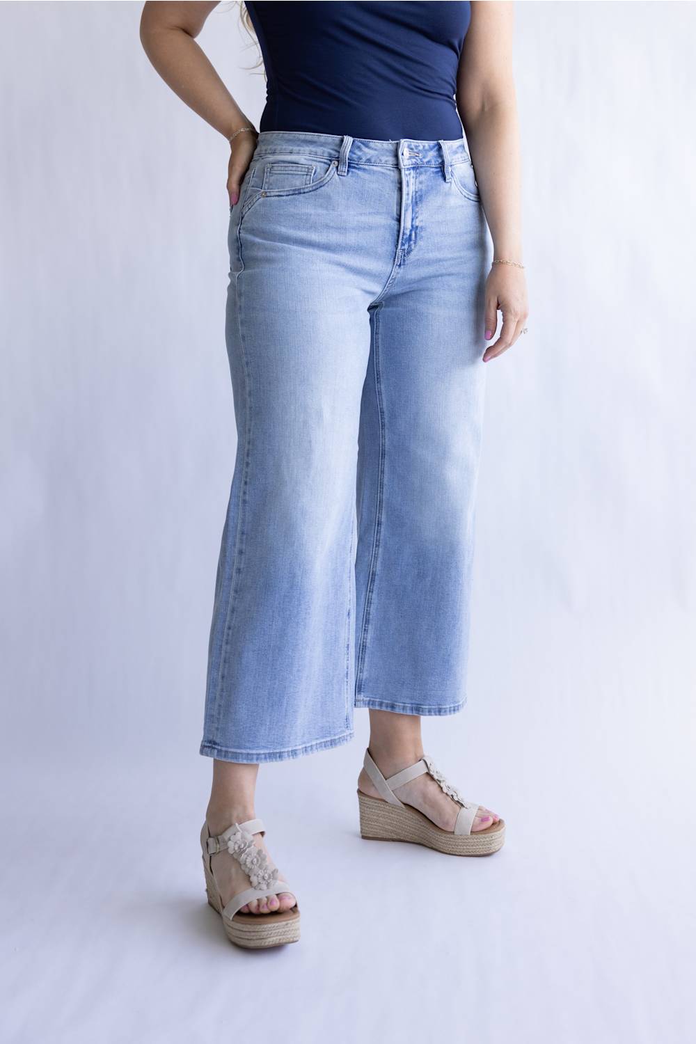 Mica Mid Rise Wide Crop Jeans for Women; Person wearing light blue wide-leg jeans and a navy top on a white background