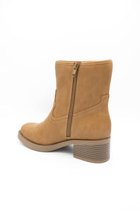 A tan suede ankle boot with a side zipper, shown from a rear three-quarter angle against a plain white background.