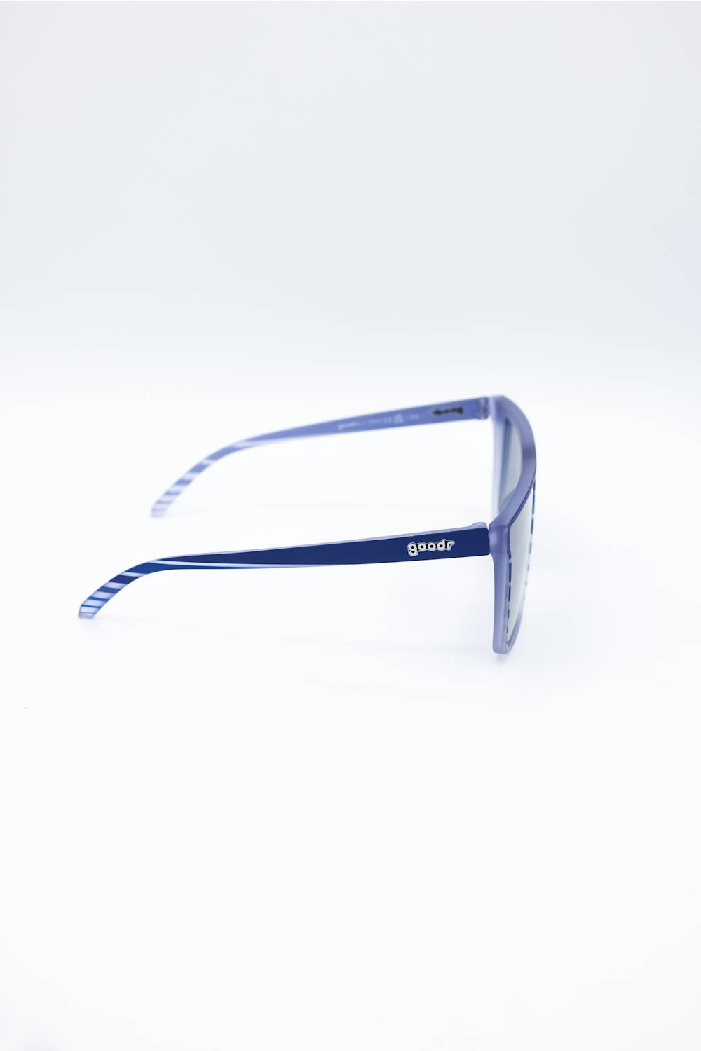 Blue acetate square sunglasses with a white striped pattern on the inner temples, shown from a side profile on a white background. The brand name 'goodr' is visible on the temple arm.