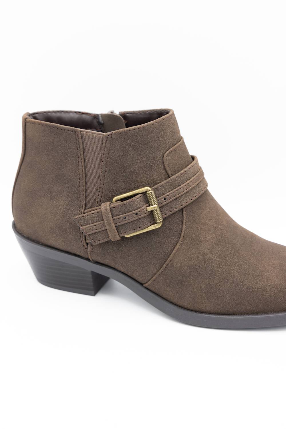 A brown suede ankle boot with a side buckle strap and a low block heel, shown from a three-quarters angle on a white background.