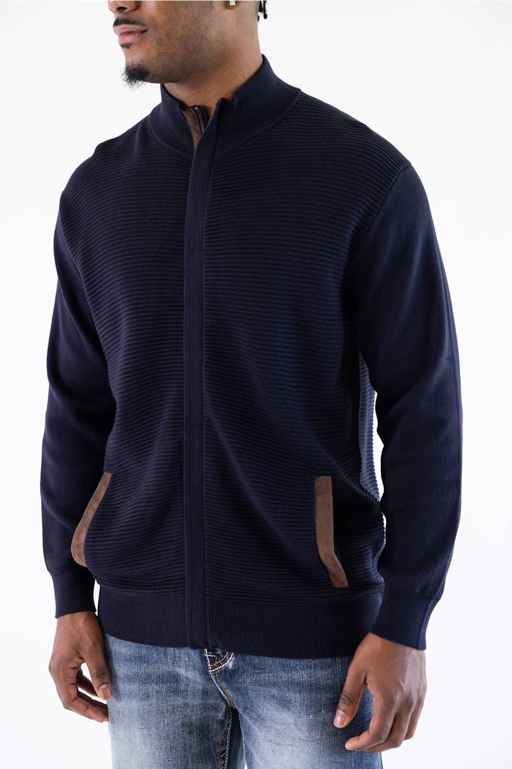 Man wearing a navy mock neck jacket standing against a white background