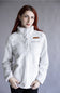 A woman with red hair wearing a white textured fleece pullover jacket with a high collar and a small brown chest patch, posed against a neutral gray studio background.