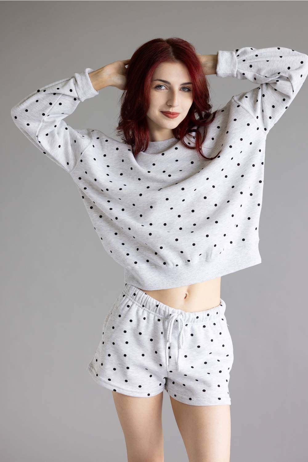 Polka Dot Fleece Crewneck for Women in Grey/Black; Woman wearing a polka dot outfit on a gray background