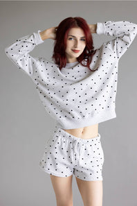 Polka Dot Fleece Crewneck for Women in Grey/Black; Woman wearing a polka dot outfit on a gray background